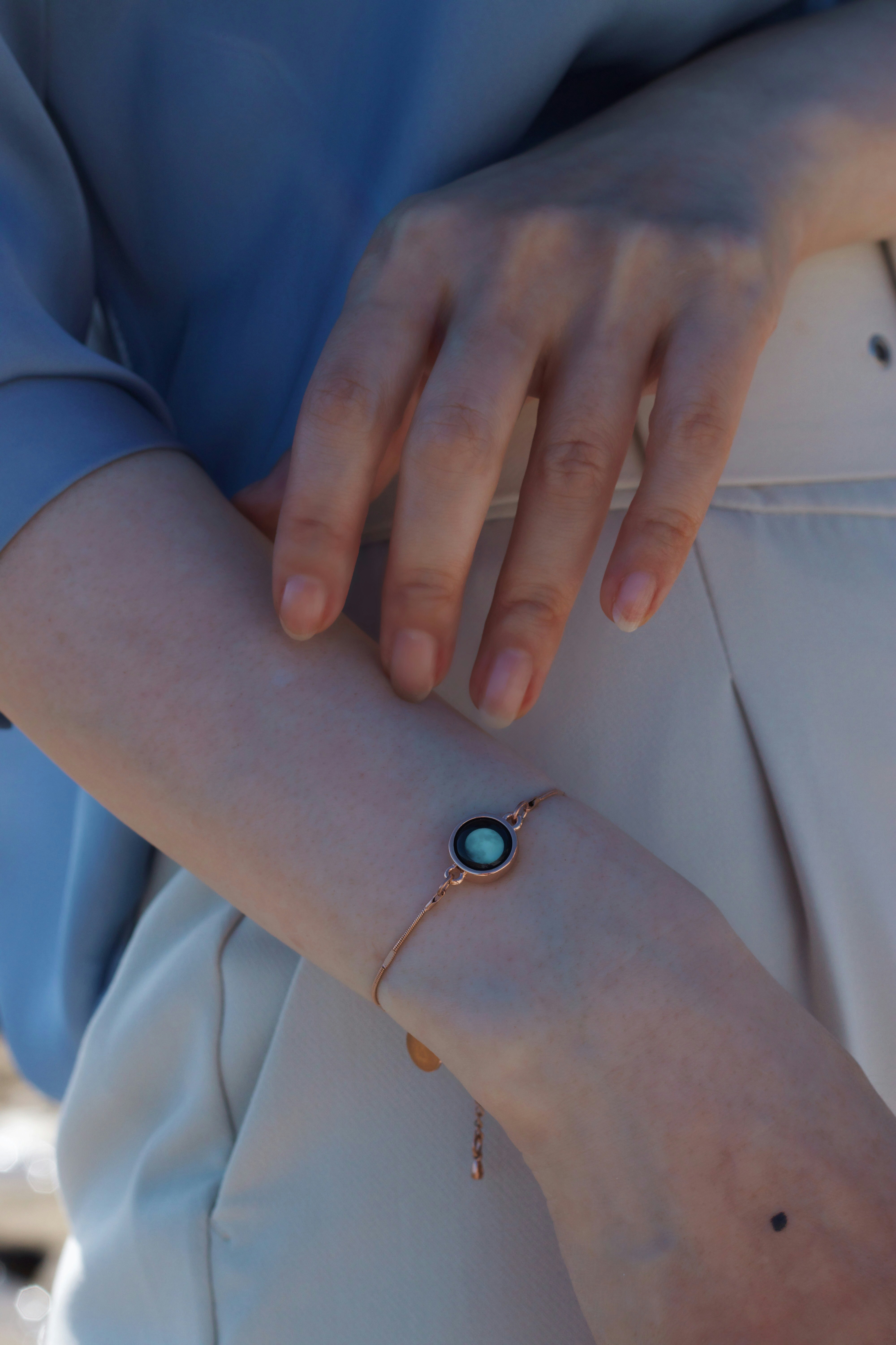 person wearing blue and silver bracelet